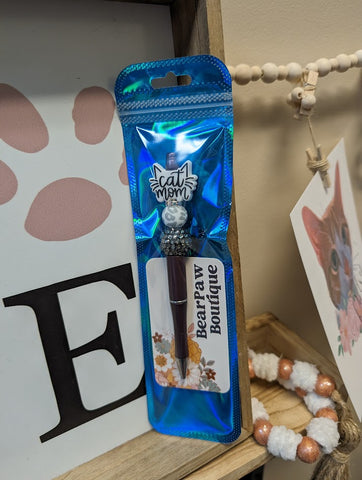 A pen that says "cat mom" with cat ears