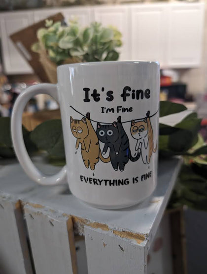 ceramic mug that says "Im fine, everythings fine" with 3 cats on the front